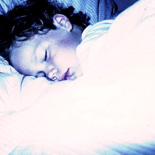 A person peacefully sleeping in bed.