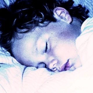 A person peacefully sleeping in bed.
