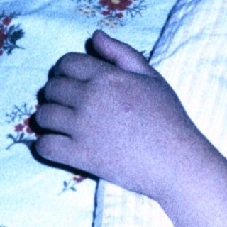 Child peacefully sleeping in bed at night.