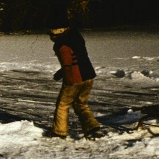 Winter scene with children playing in snow-covered park.