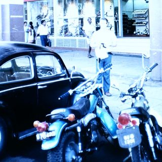 Vintage Bata shoe store with motorcycles parked outside.