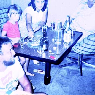Family gathering around a table indoors.
