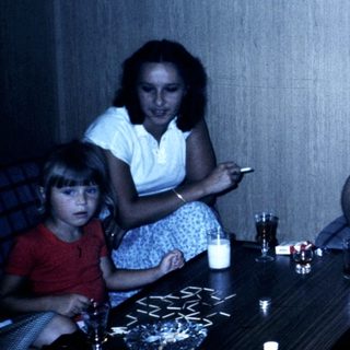 Family gathering indoors in casual summer attire.