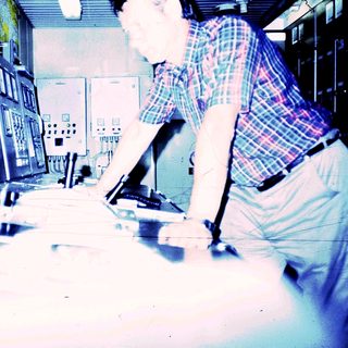 Control room operator monitoring industrial equipment.