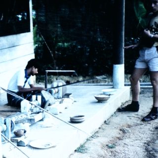 Traditional pottery workshop with artisan at wheel.