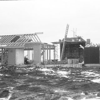 Construction site near waterfront during winter.