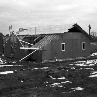 House under construction with collapsed roof section.