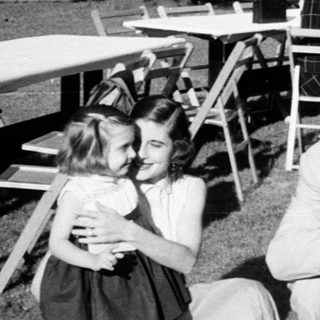 Family gathering at an outdoor picnic or dinner.