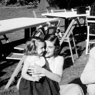 Family gathering at an outdoor picnic or dinner.