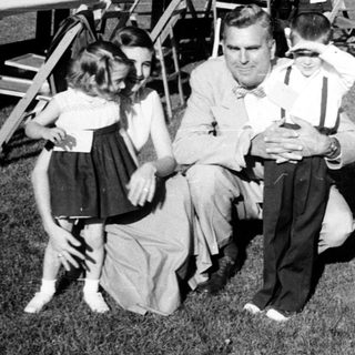 Family gathering at outdoor evening event.
