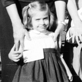 Family portrait from mid-20th century outdoors.