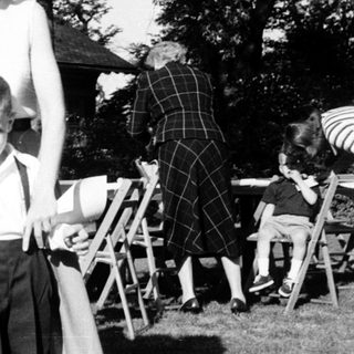 Family portrait from mid-20th century outdoors.