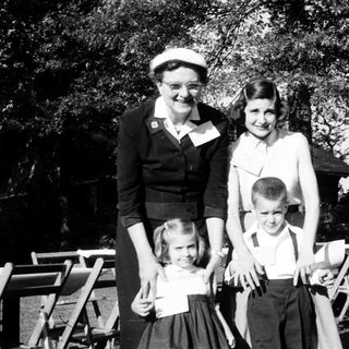 Family portrait from mid-20th century outdoors.