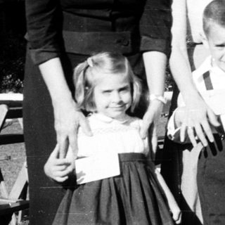 Family portrait from mid-20th century outdoors.