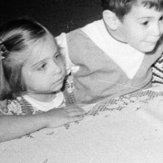 Family gathering celebrating a birthday with cake.