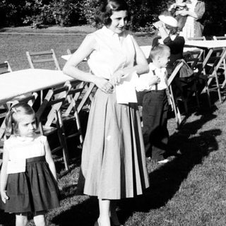 Family gathering at outdoor picnic setup.