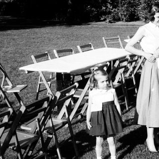 Family gathering at outdoor picnic setup.