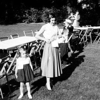 Family gathering at outdoor picnic setup.