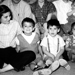 Family portrait from mid-20th century with adults and children.
