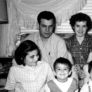 Family portrait from mid-20th century with adults and children.