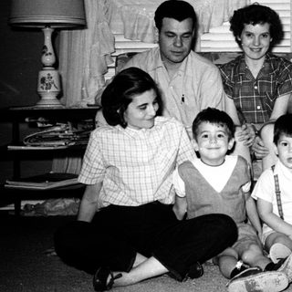 Family portrait from mid-20th century with adults and children.