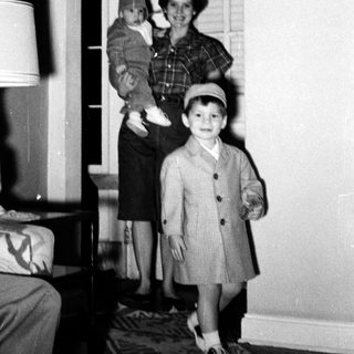 Family portrait in 1950s-style home interior.