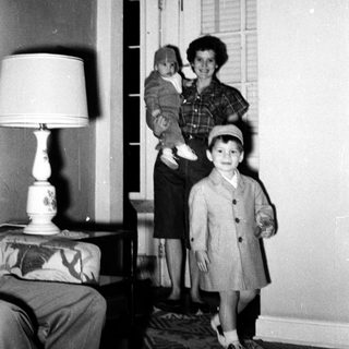 Family portrait in 1950s-style home interior.