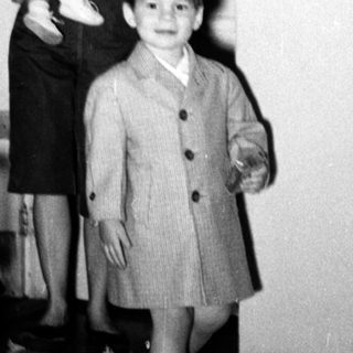 Family portrait in 1950s-style home interior.