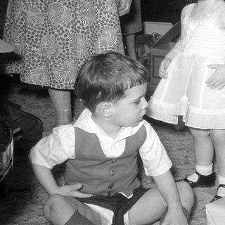 Children and women in a domestic indoor setting.