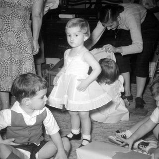 Children and women in a domestic indoor setting.