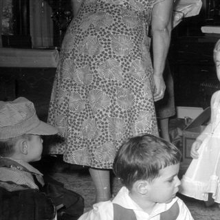 Children and women in a domestic indoor setting.
