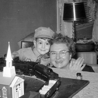 Child and woman with a model train set.