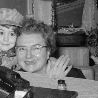 Child and woman with a model train set.