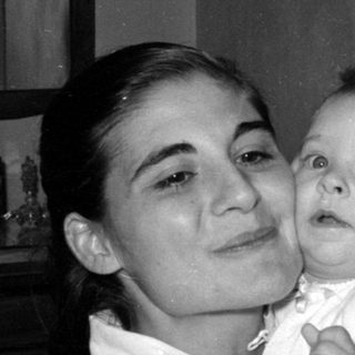 Woman and infant in a domestic interior.