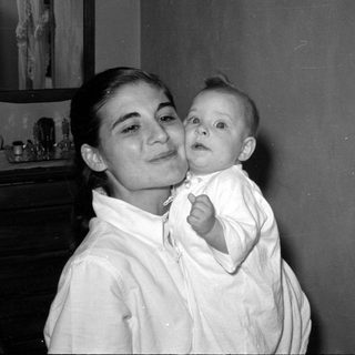 Woman and infant in a domestic interior.