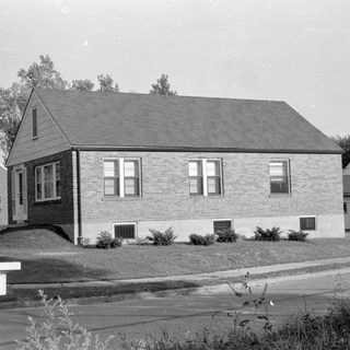 Single-story brick house in a residential neighborhood.