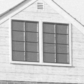 Small brick building with a gabled roof.