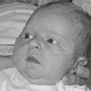 Three infants in hospital bassinets, black and white.