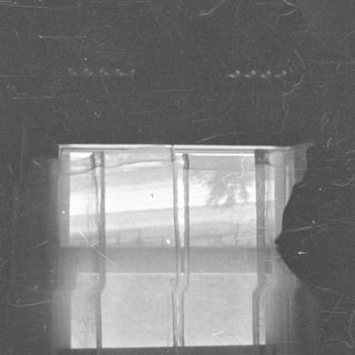 Damaged negative showing a partial view of a window.