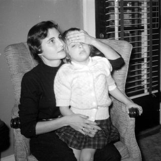 Woman and child sitting in an armchair.