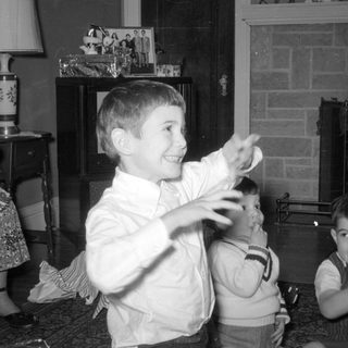 Three boys and a woman in a living room.
