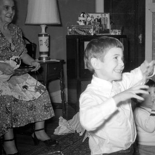Three boys and a woman in a living room.
