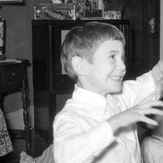 Three boys and a woman in a living room.