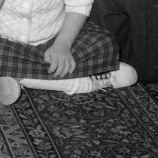 Four children and a man in a living room.