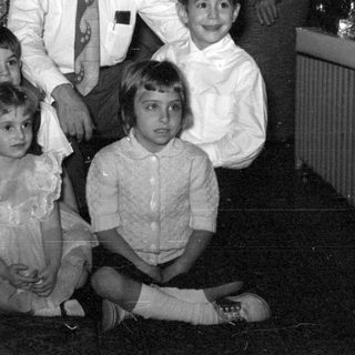 Group portrait of adults and children indoors.
