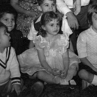 Group portrait of adults and children indoors.