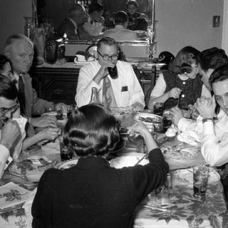Group of people dining at a table.