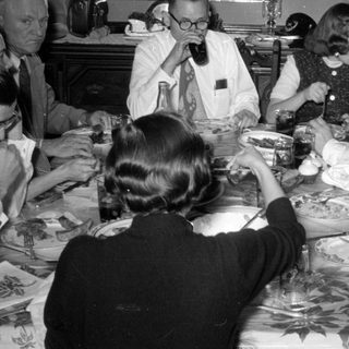 Group of people dining at a table.