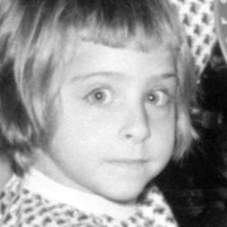 Child with educational game by a Christmas tree.
