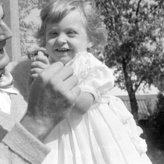 Man in bow tie and girl in white dress.